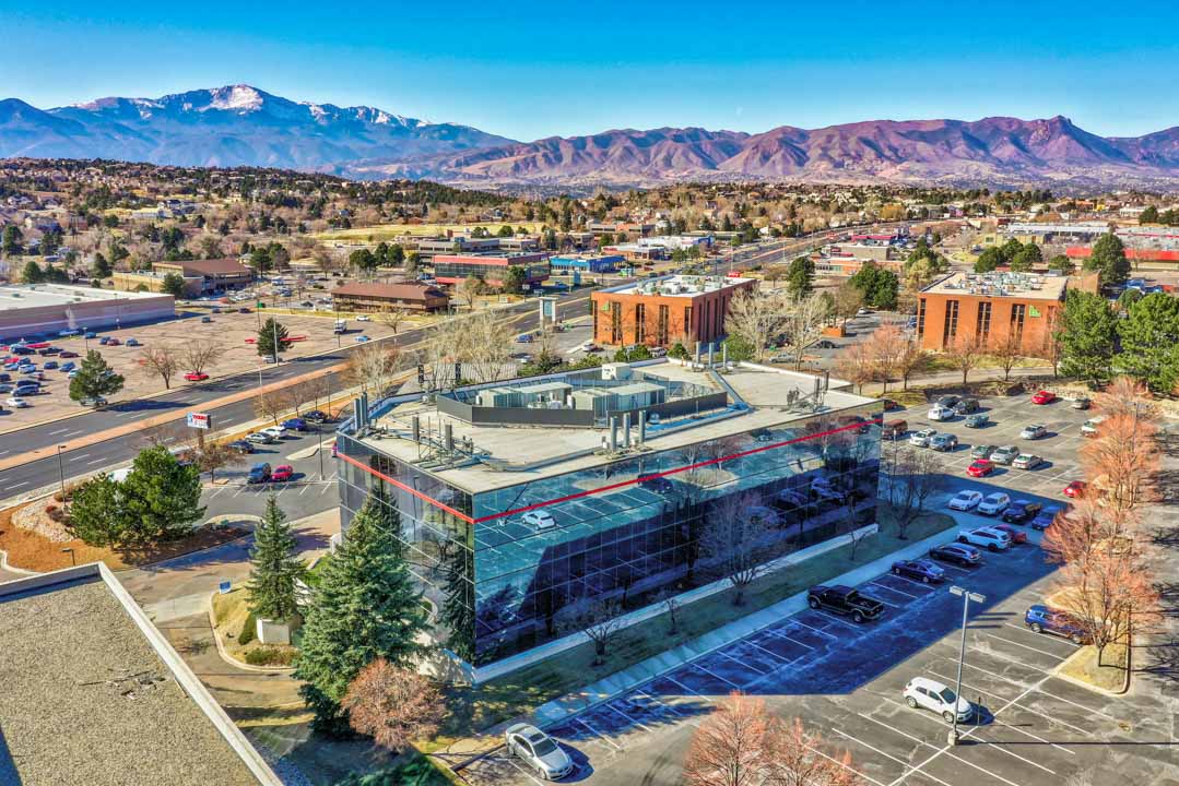 Aerial view of a building in Colorado Springs, showcasing its architecture and surrounding landscape.