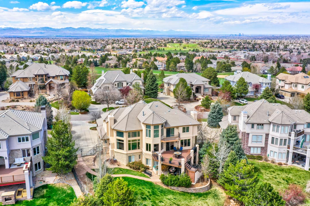 A scenic view showcasing various neighborhoods in Colorado, highlighting their unique architecture and natural surroundings.